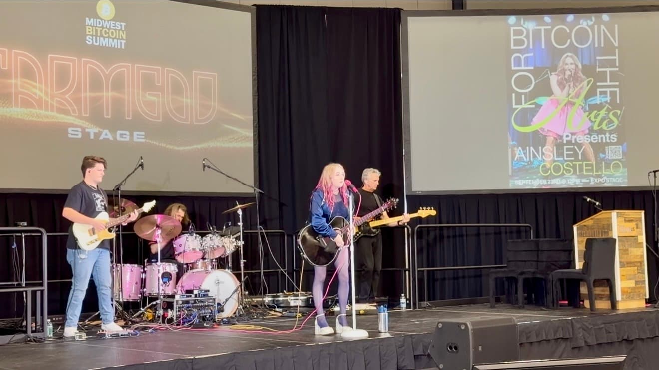 Ainsley Costello performing with her band at Bitcoin Arts Park, Midwest Bitcoin Summit